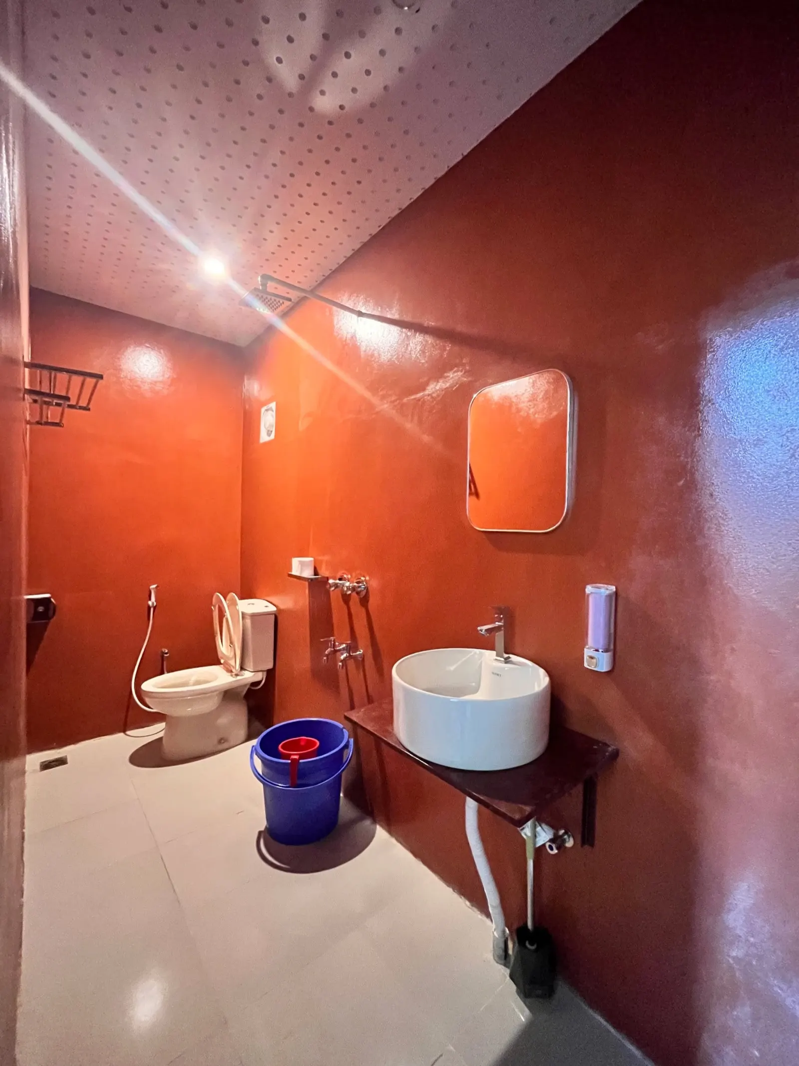 An attached bathroom with a vessel sink