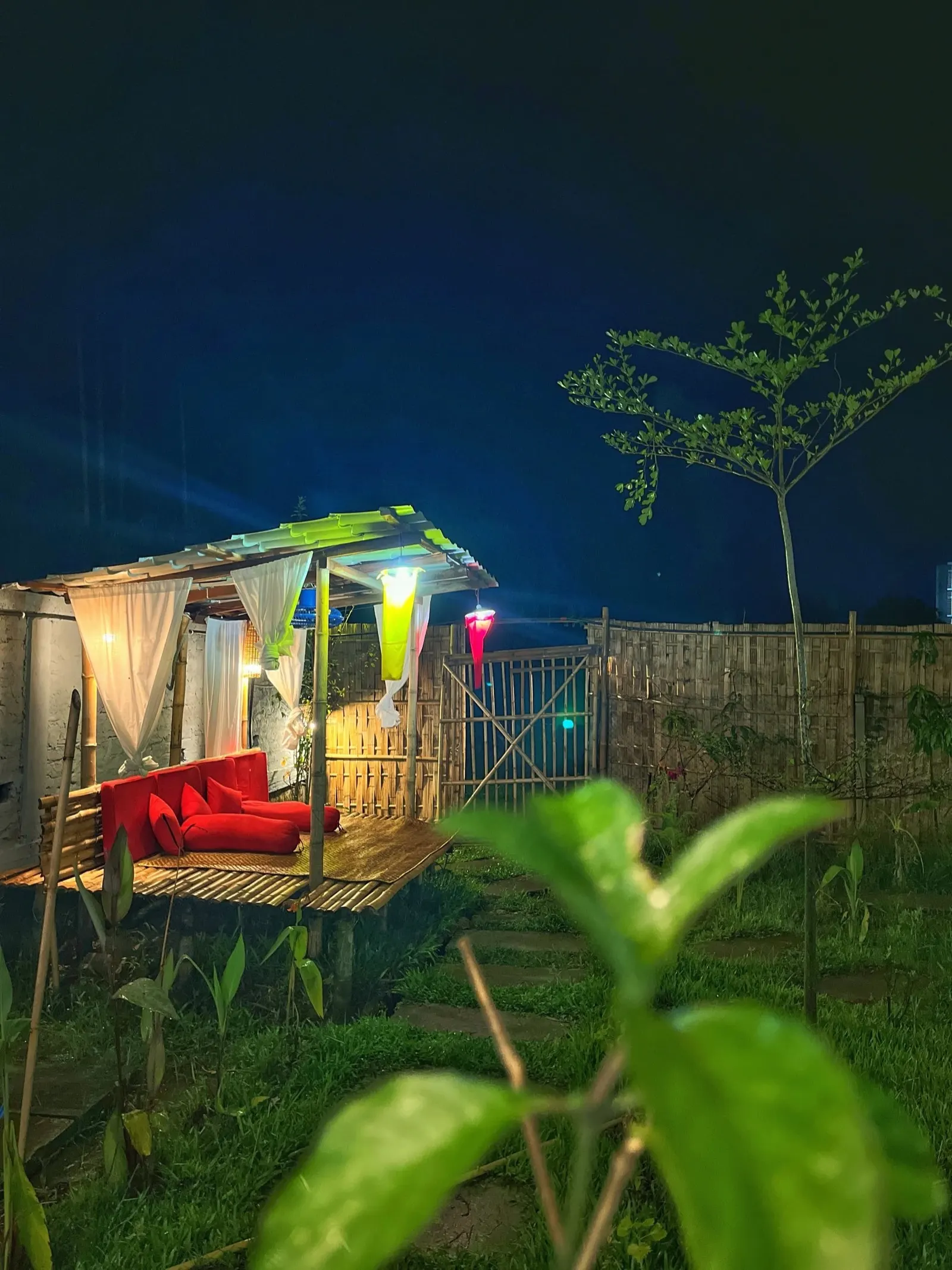 The cushioned gazebo glowing at night