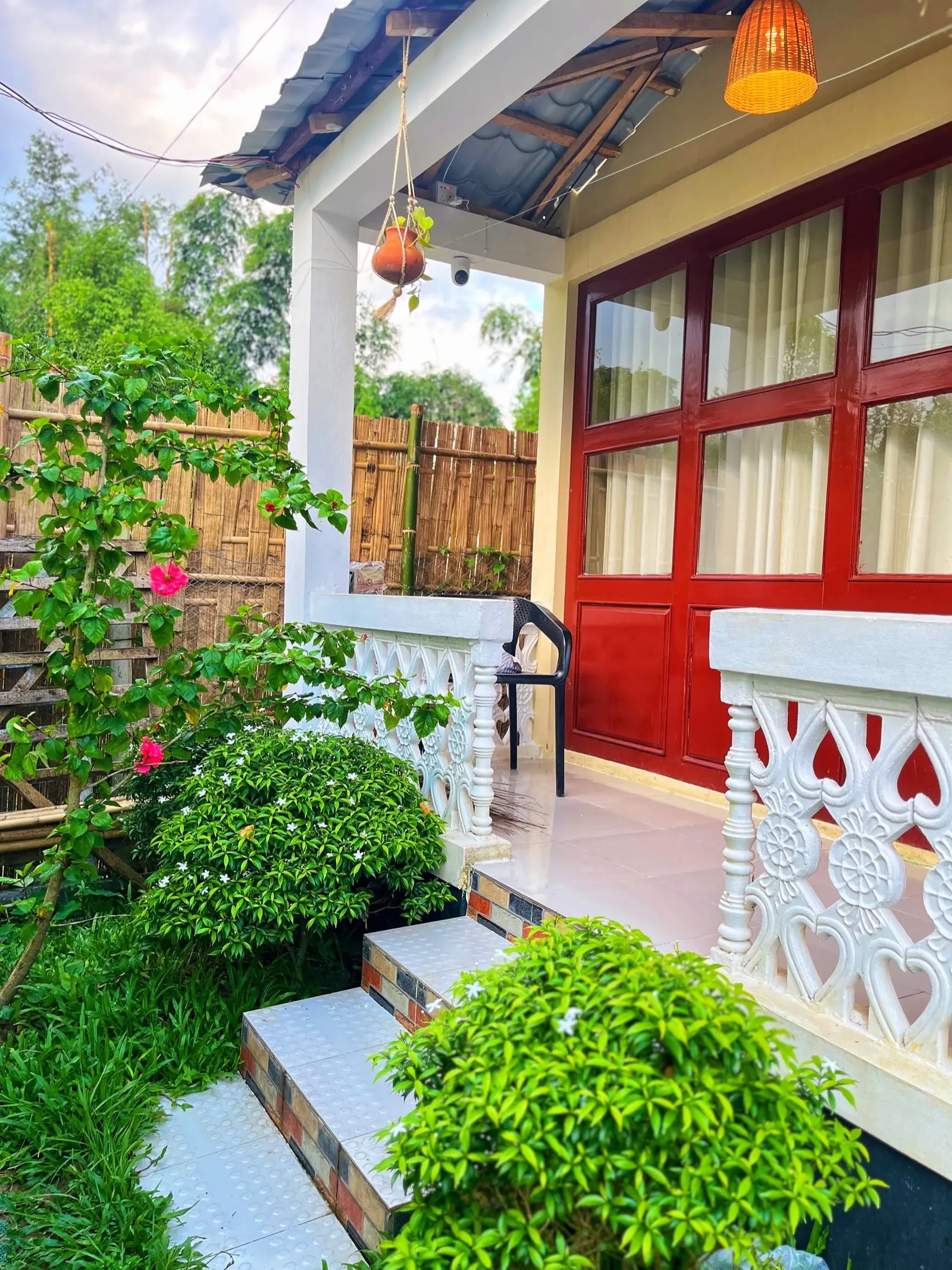 The red door and lattice porch outside a guest room